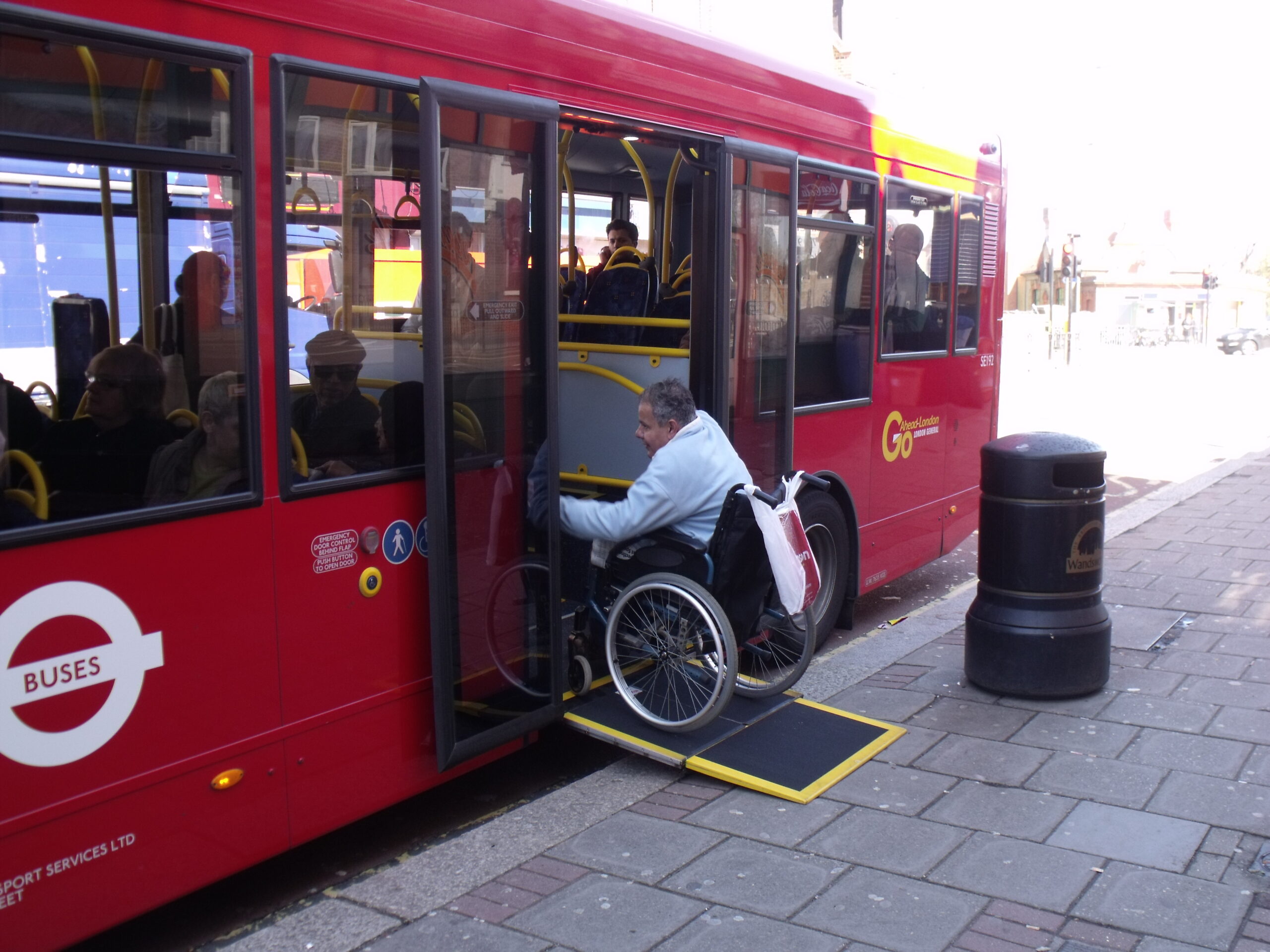 Wheelchair user entering bus