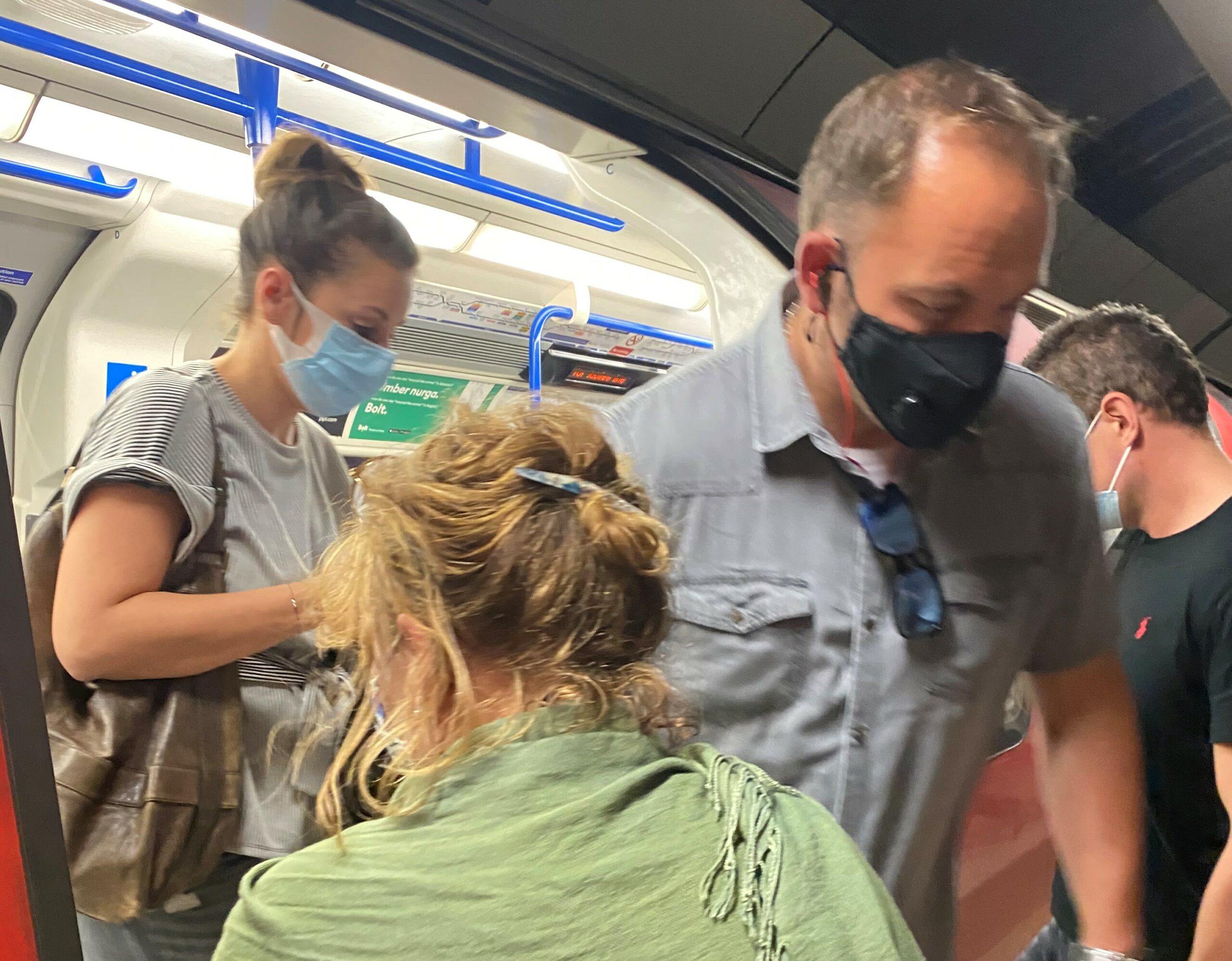 Passengers with face coverings exiting Tube