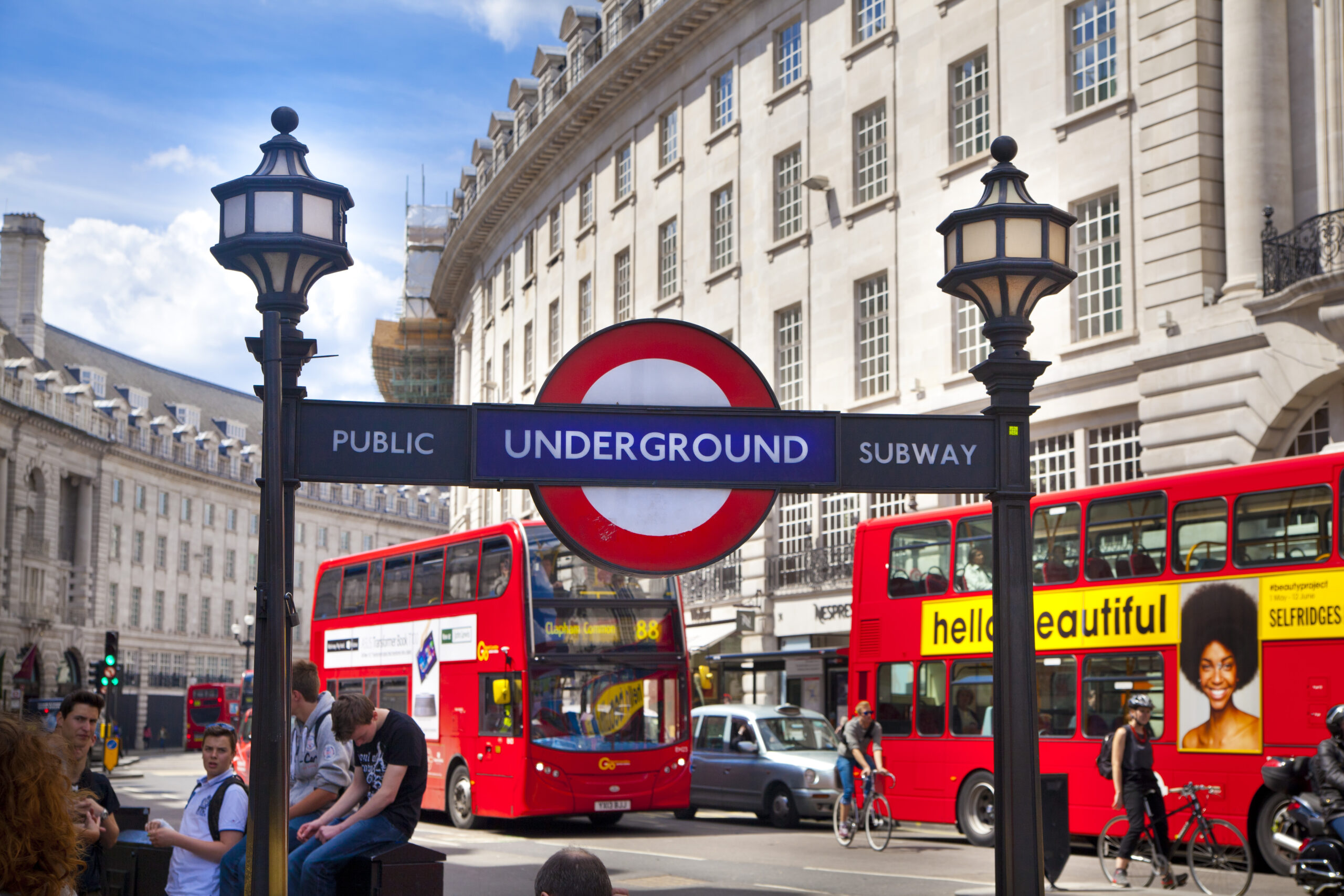 London Underground sign with buses in background