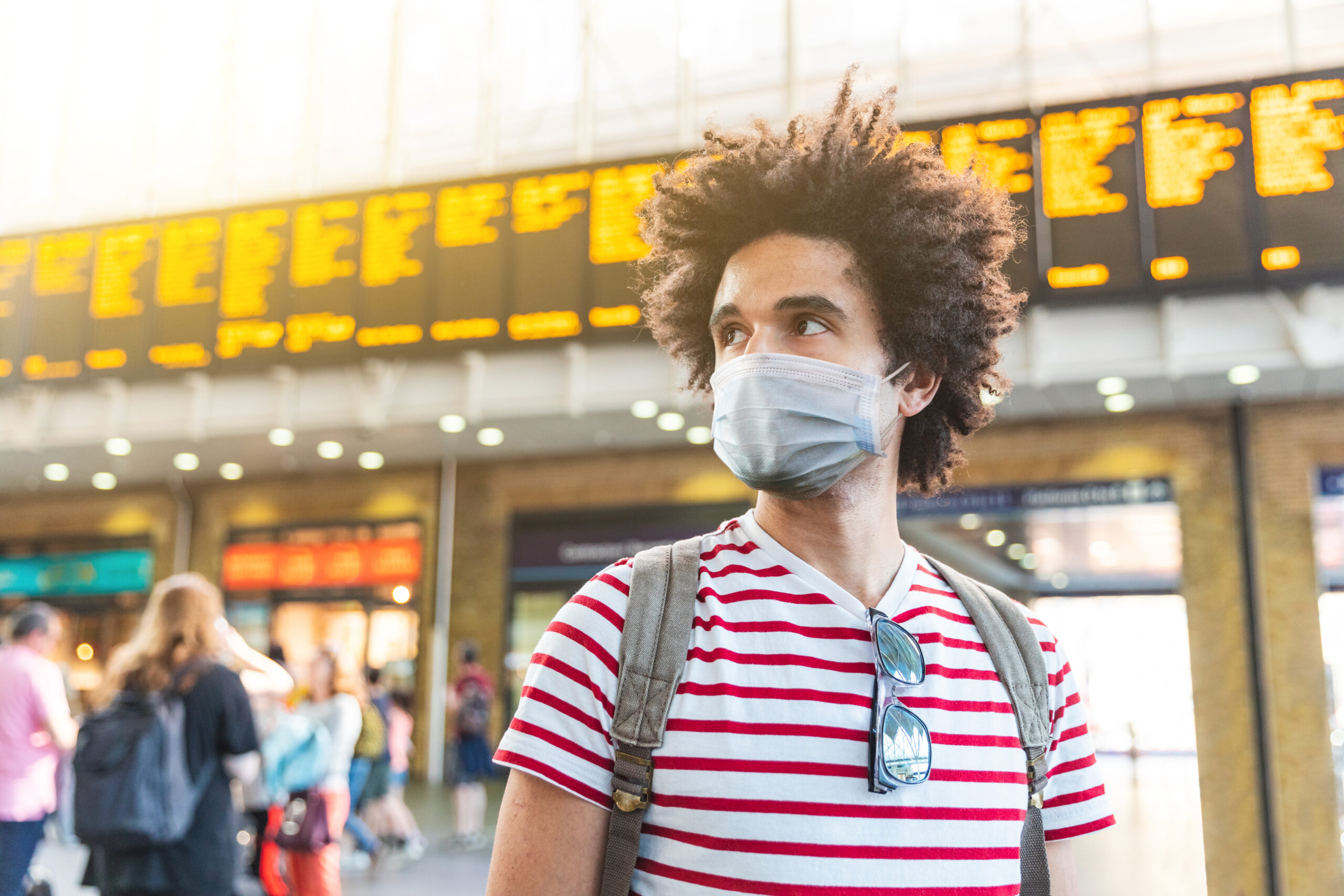 man wearing face covering at London train station