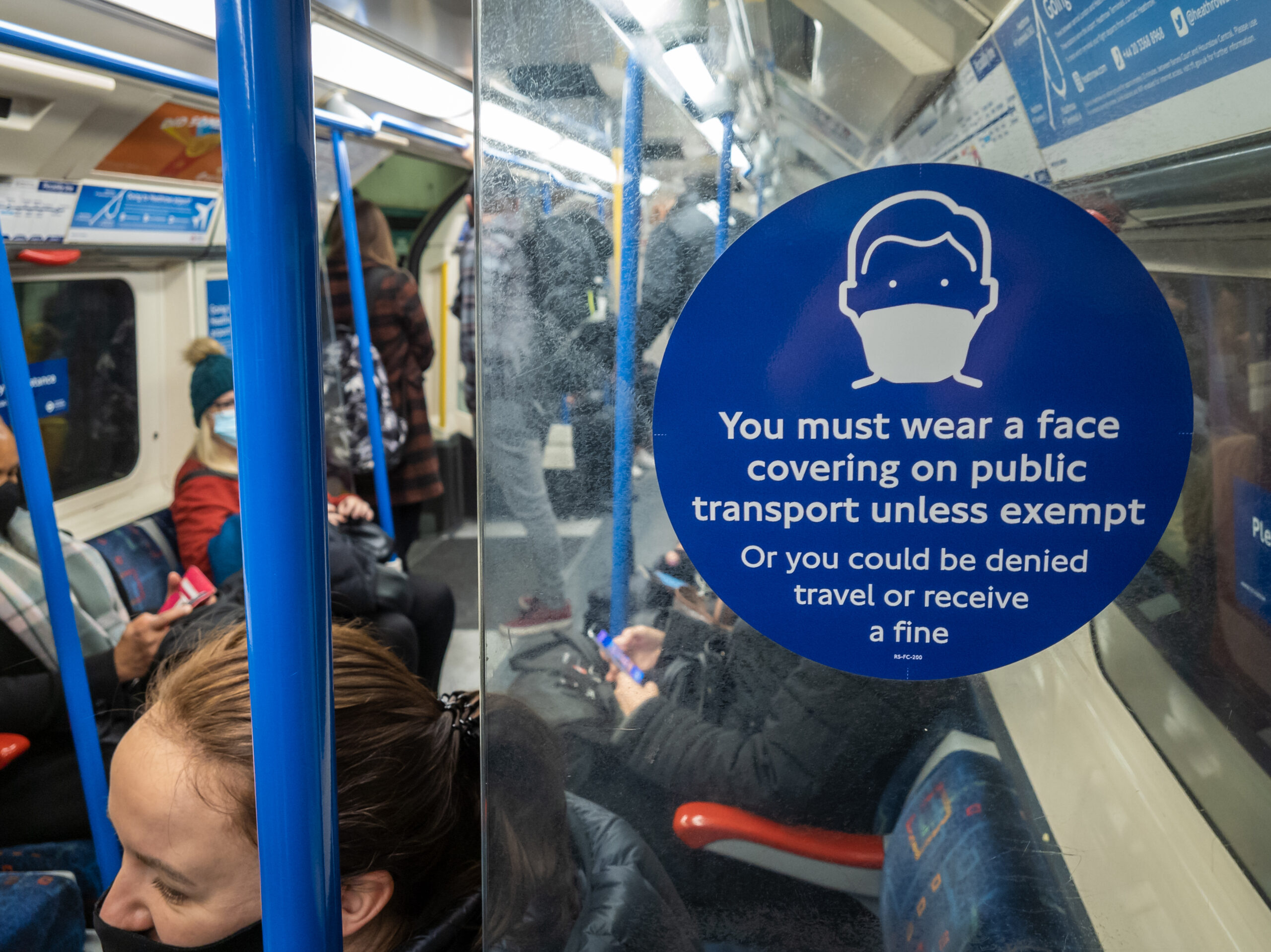 face covering sign on Tube with passengers