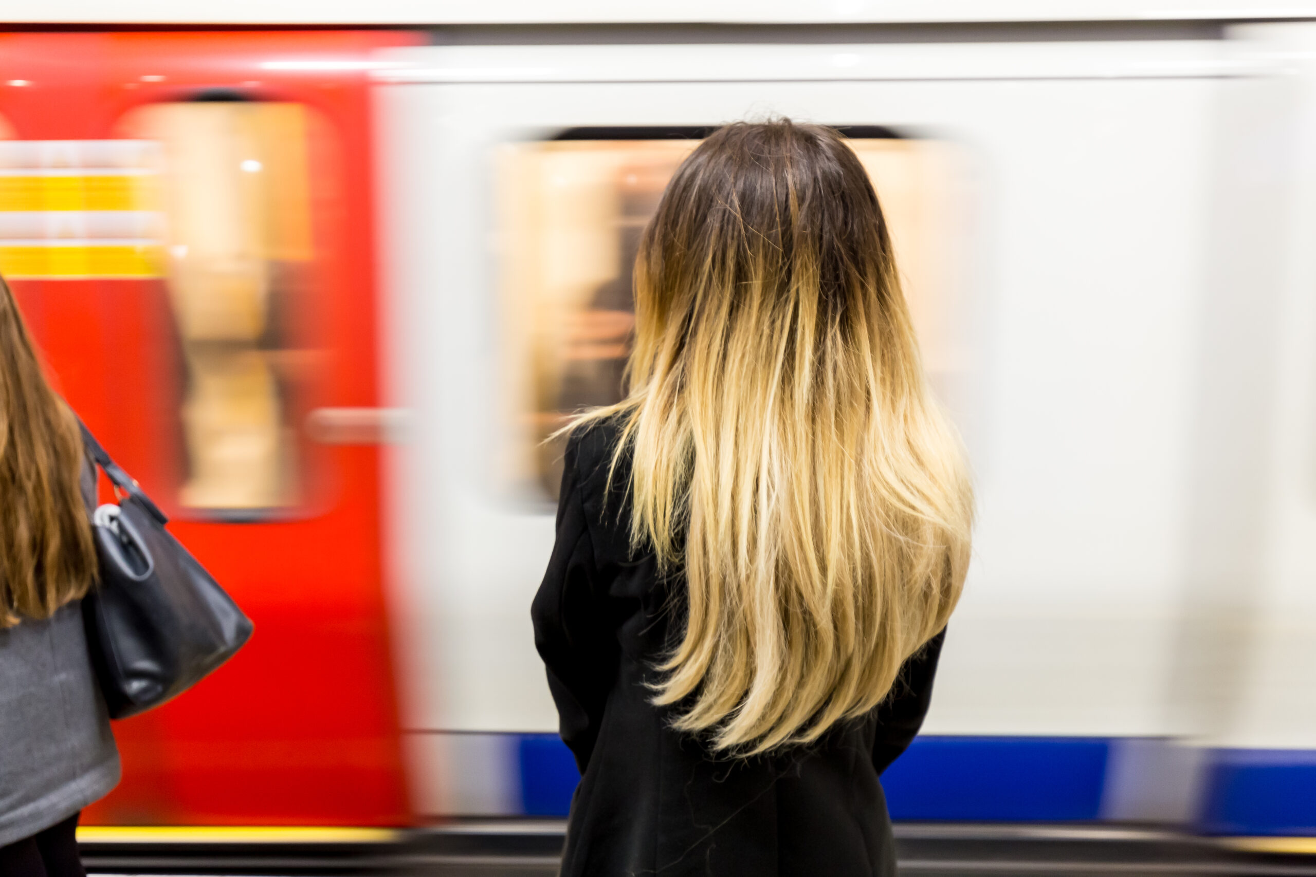 Woman on London Underground platform with back to camera