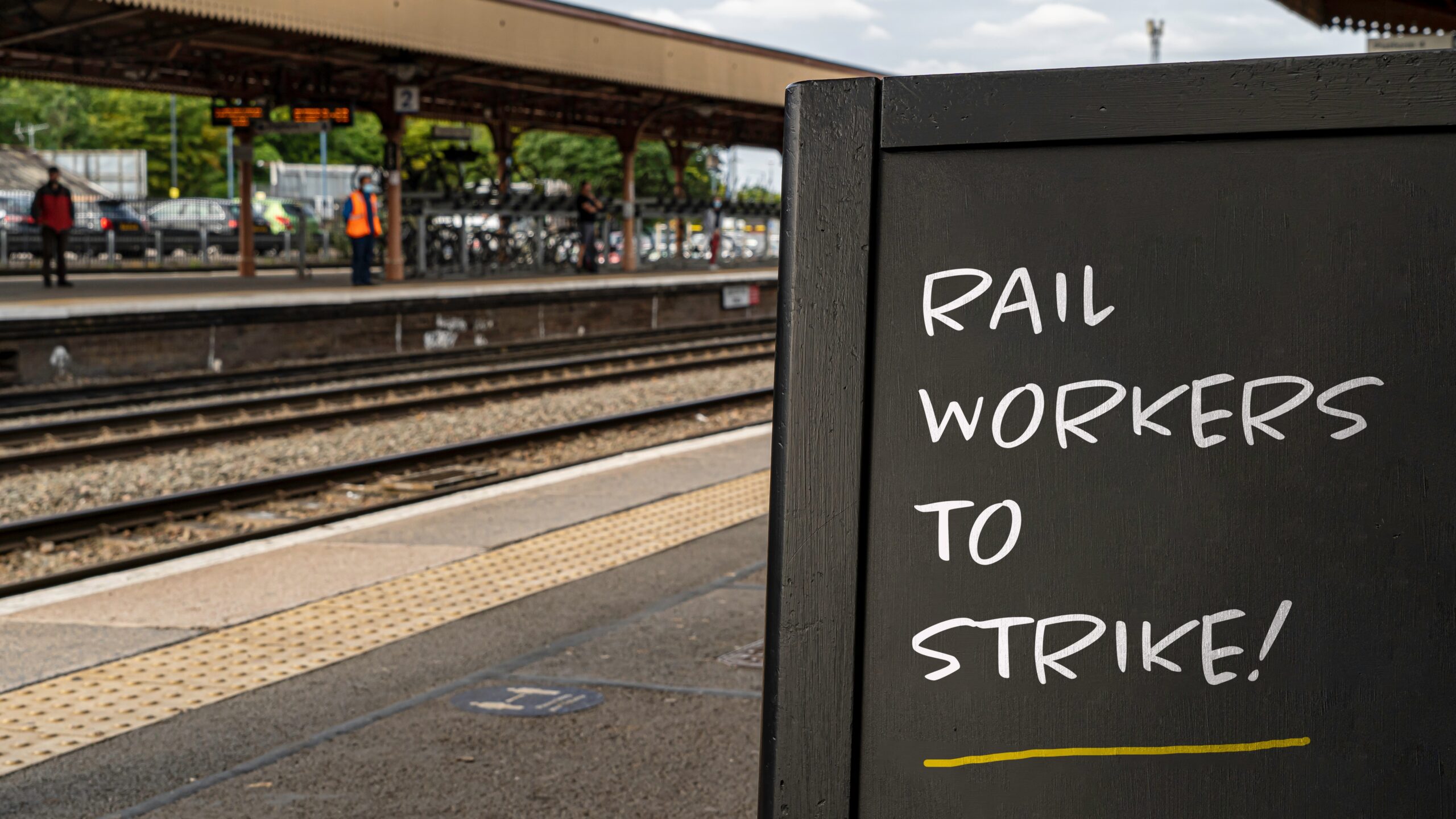 Station with a chalk board saying 'rail workers to strike'