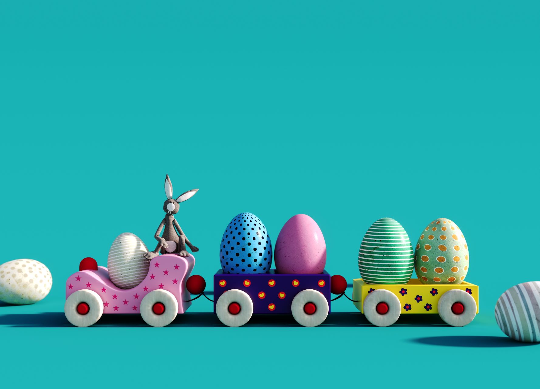 A colourful toy train carrying Easter eggs and an Easter bunny