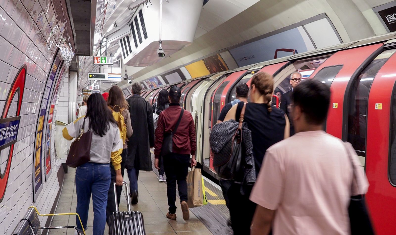 People walking on a platform at Oxford Circus station