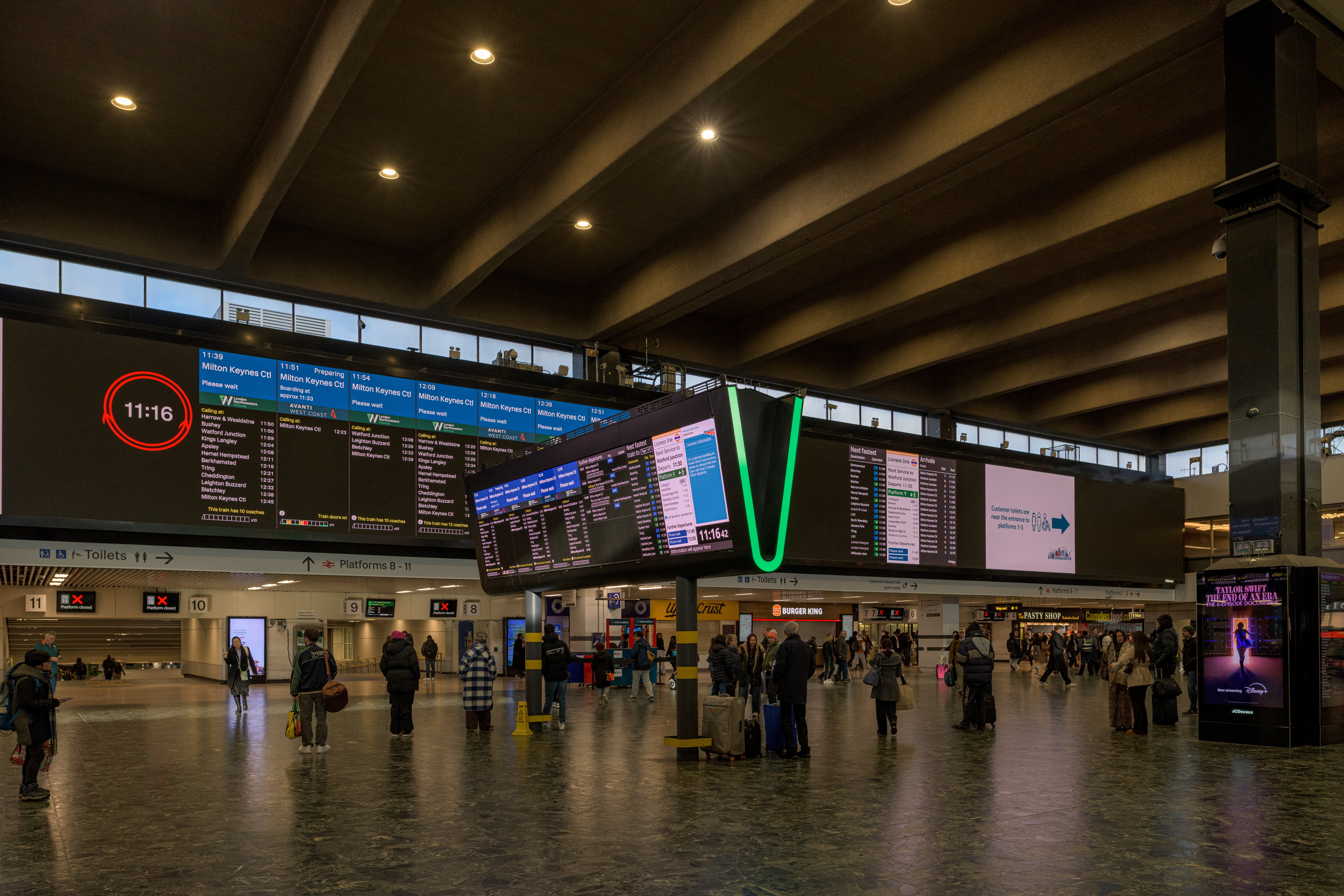 The concourse at Euston station showing digital information screens
